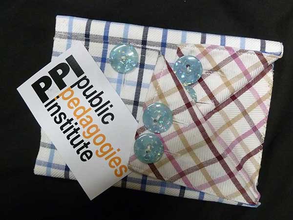 Image of pocket with paper saying 'ppi - public pedagogies institute'